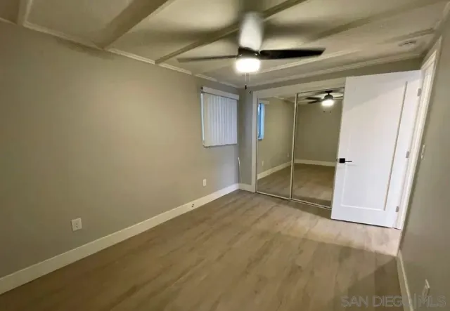 an empty room with wooden floor