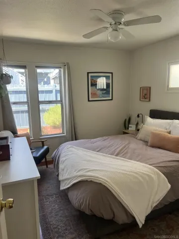 a bedroom with a bed and a desk with chair