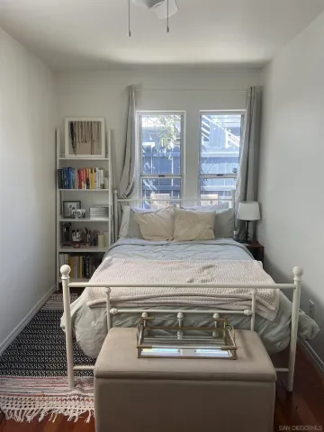 a bedroom with a bed and a window