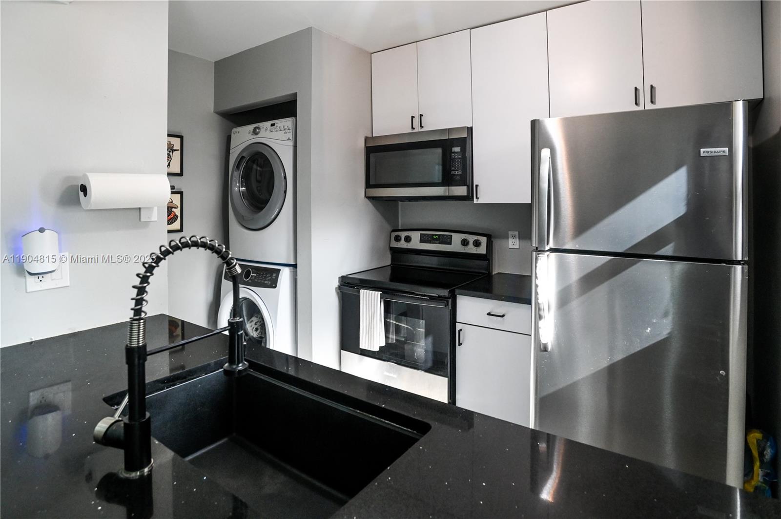 a kitchen with a refrigerator and a stove top oven