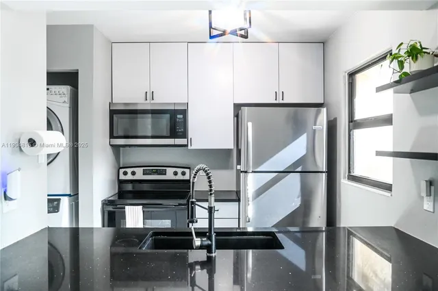 a kitchen with kitchen island a counter space a sink and appliances