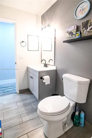 a bathroom with a toilet a sink and a mirror