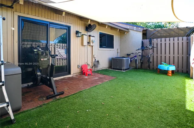a backyard of a house with table and chairs
