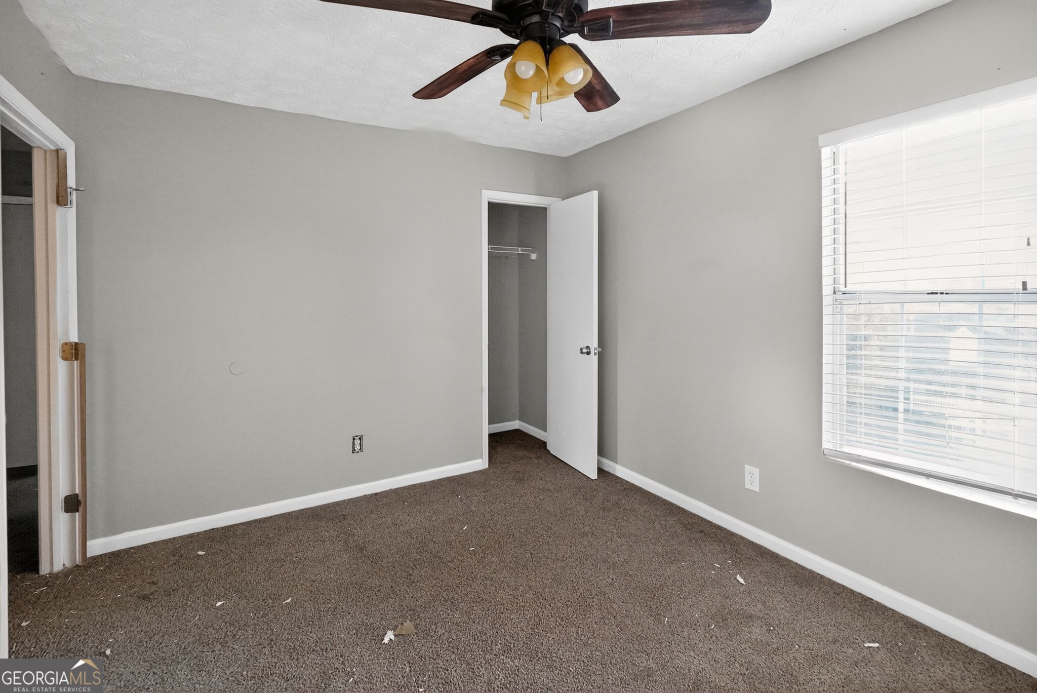3840 Rolling Place Conley, GA 30288 - Photo 22 of 35 an empty room with a window and a ceiling fan