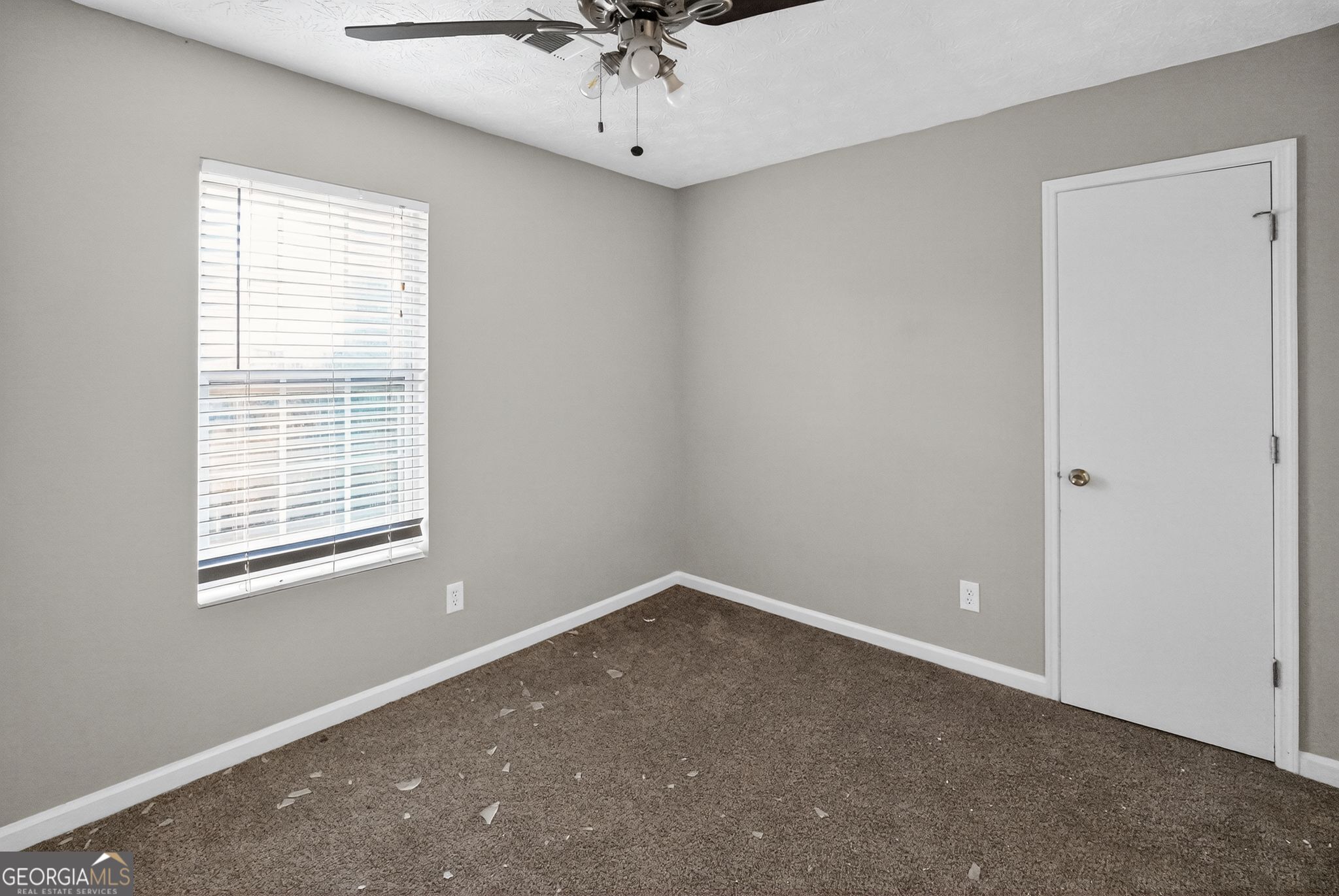 3840 Rolling Place Conley, GA 30288 - Photo 30 of 35 an empty room with a window and a fan