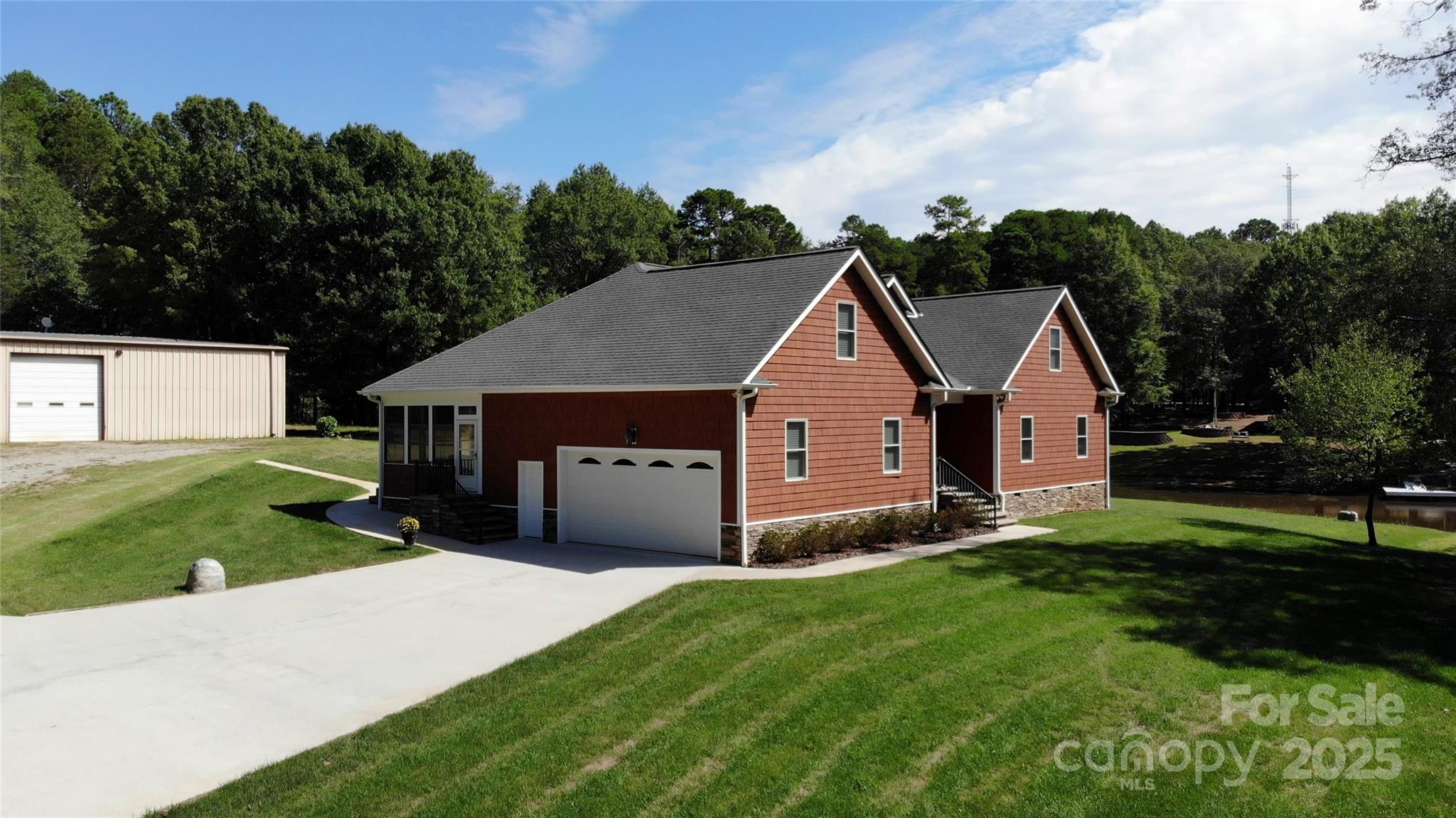 15027 Beatties Ford Road Huntersville, NC 28078 - Photo 1 of 34 a aerial view of a house next to a big yard and large trees