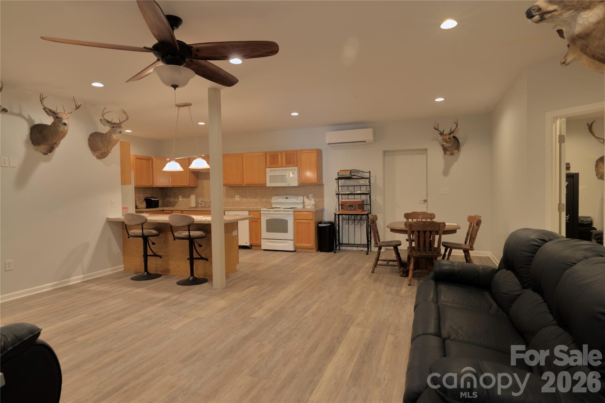 15027 Beatties Ford Road Huntersville, NC 28078 - Photo 11 of 33 a living room with lots of furniture and kitchen view