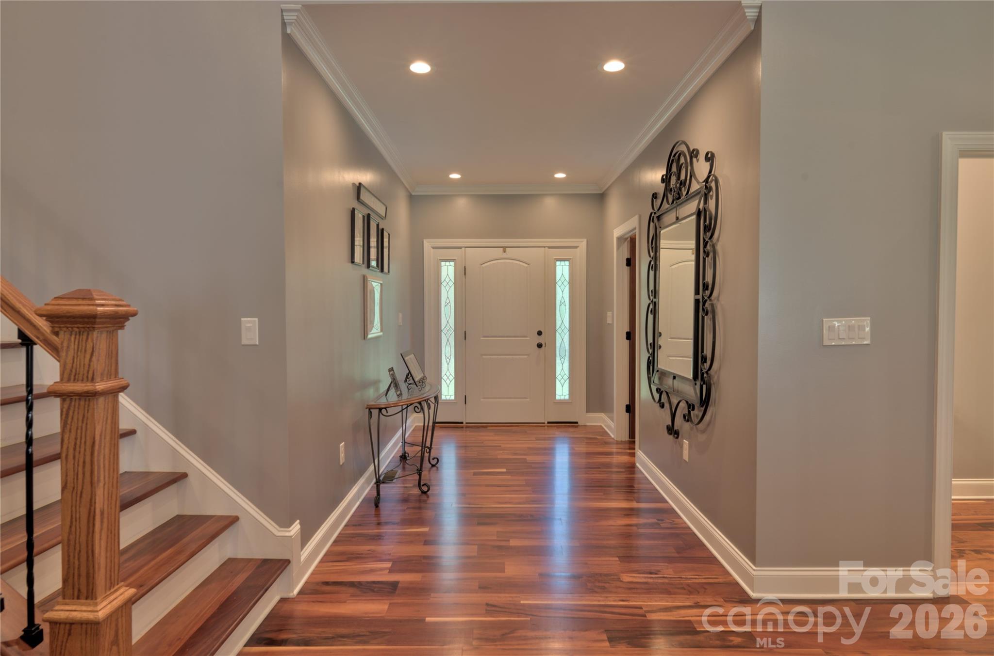 15027 Beatties Ford Road Huntersville, NC 28078 - Photo 12 of 33 a view of a hallway with the wooden floor and staircase