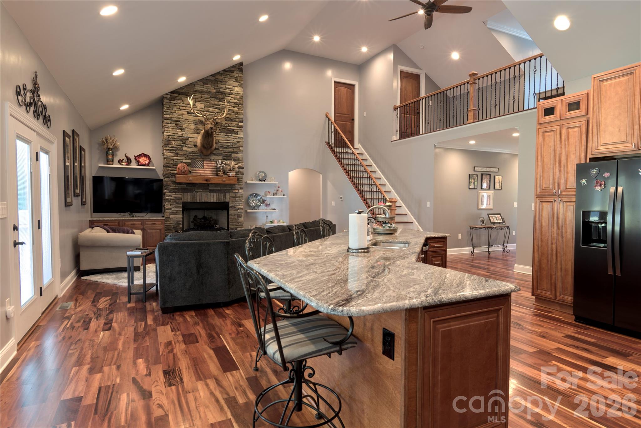 15027 Beatties Ford Road Huntersville, NC 28078 - Photo 14 of 33 a kitchen with stainless steel appliances granite countertop a refrigerator a stove and a wooden floors