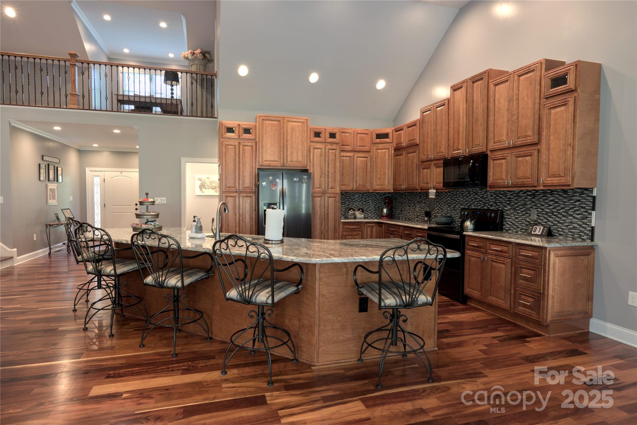 15027 Beatties Ford Road Huntersville, NC 28078 - Photo 16 of 34 a kitchen with kitchen island granite countertop a stove a sink a dining table and chairs