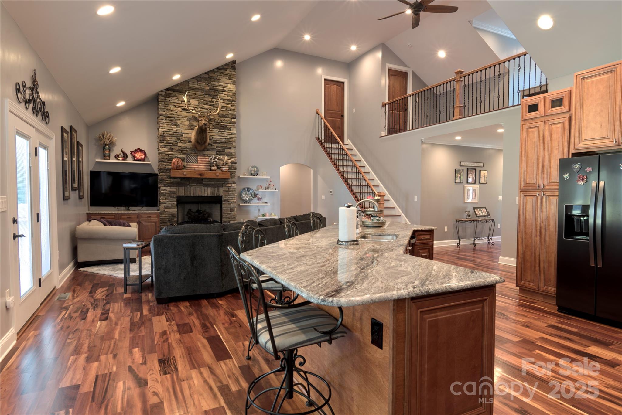 15027 Beatties Ford Road Huntersville, NC 28078 - Photo 17 of 34 a kitchen with stainless steel appliances granite countertop a refrigerator a stove and a wooden floors