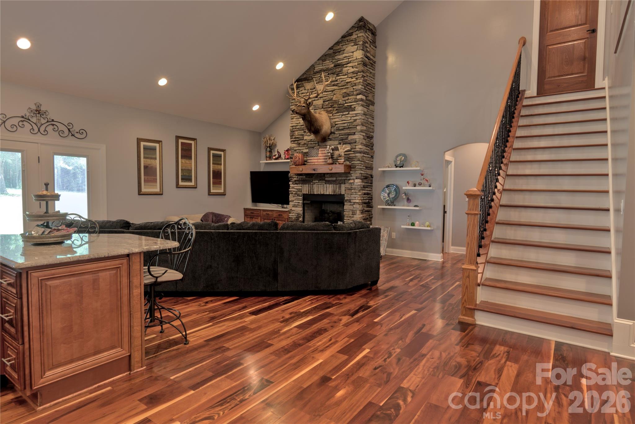 15027 Beatties Ford Road Huntersville, NC 28078 - Photo 17 of 33 a living room with furniture a flat screen tv and a fireplace