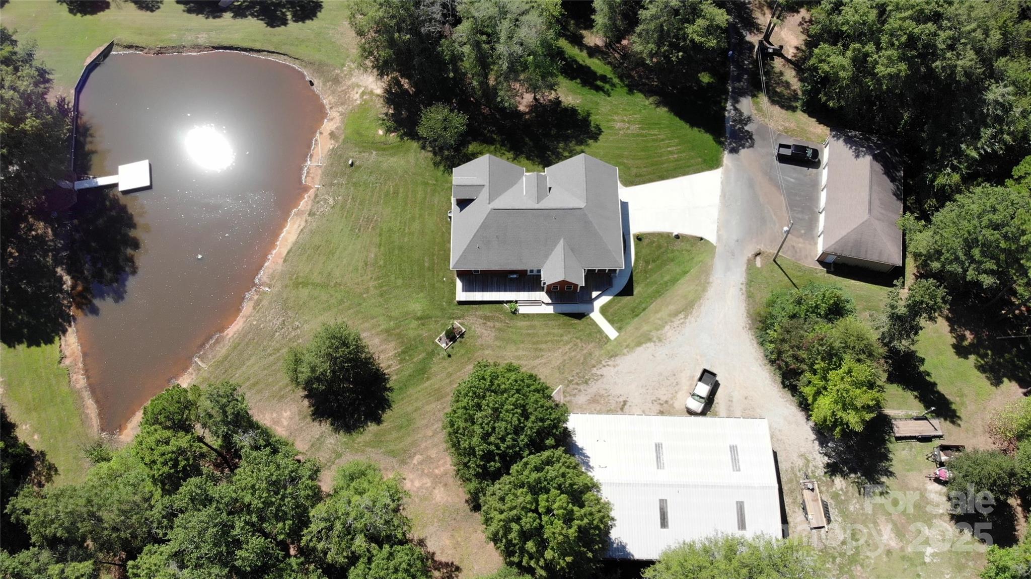 15027 Beatties Ford Road Huntersville, NC 28078 - Photo 2 of 34 an aerial view of a house with a yard and garden