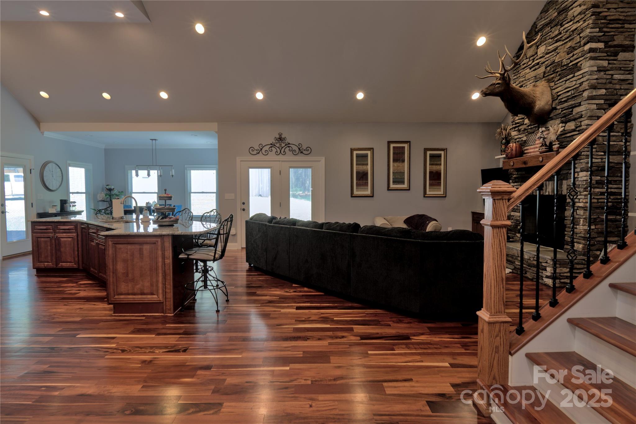15027 Beatties Ford Road Huntersville, NC 28078 - Photo 21 of 34 a living room with furniture and a wooden floor