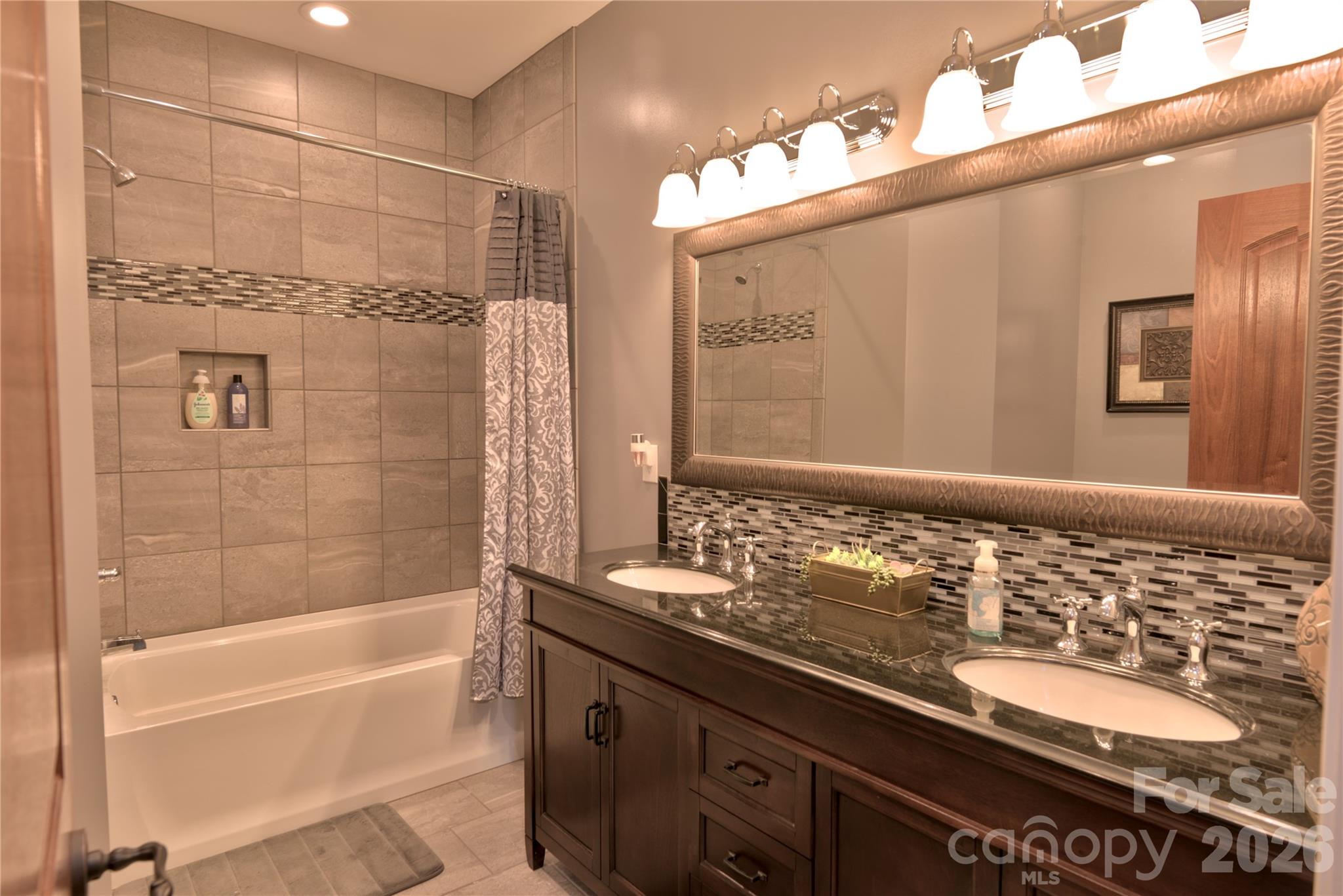 15027 Beatties Ford Road Huntersville, NC 28078 - Photo 23 of 33 a bathroom with a granite countertop sink and a mirror