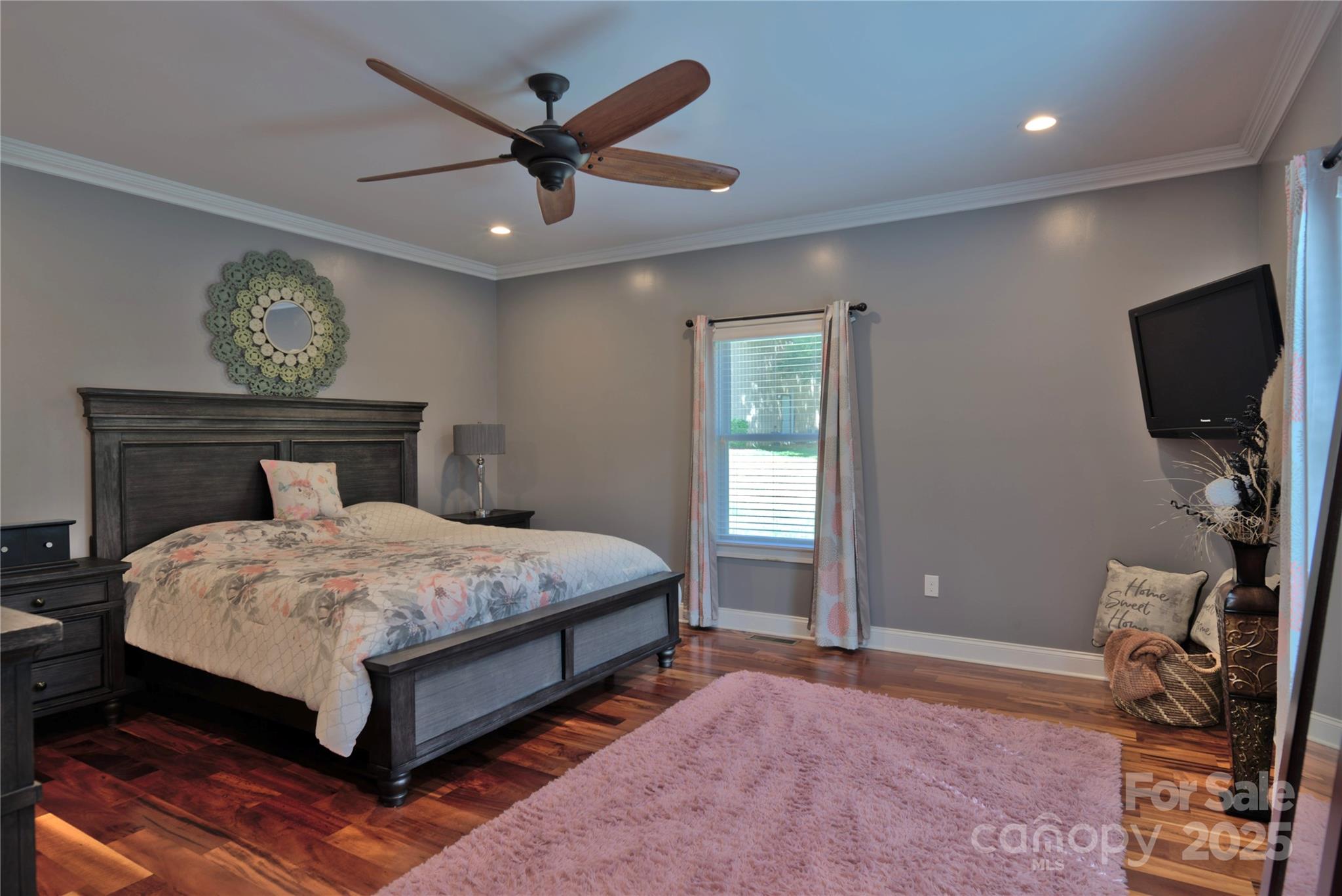 15027 Beatties Ford Road Huntersville, NC 28078 - Photo 24 of 34 a bedroom with a bed and a flat screen tv