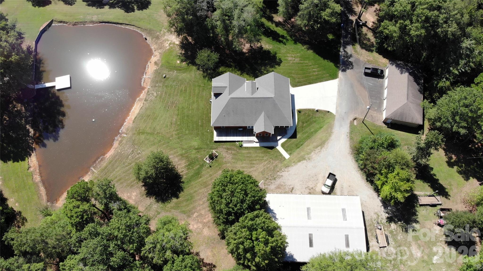 15027 Beatties Ford Road Huntersville, NC 28078 - Photo 5 of 33 an aerial view of a house with a yard and garden