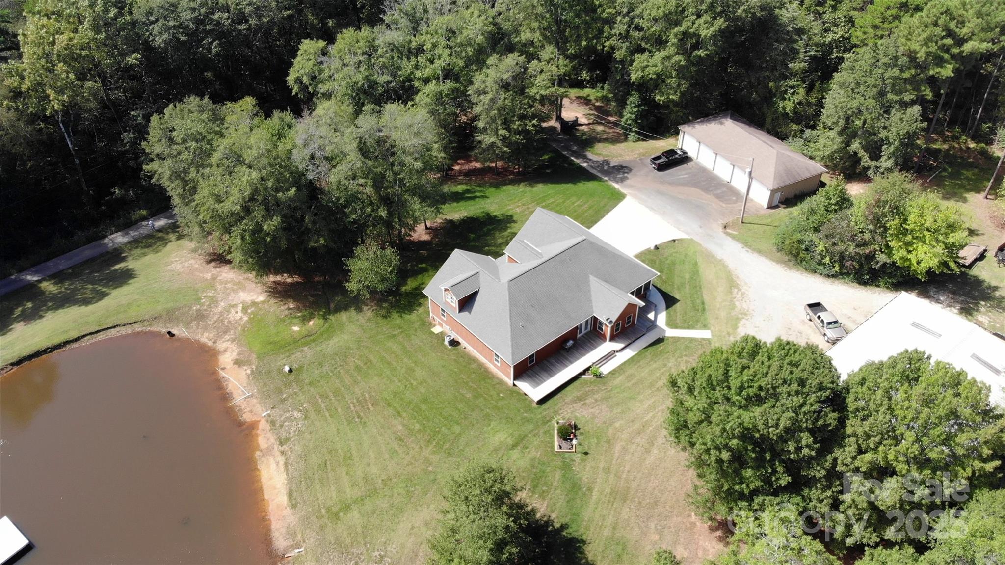 15027 Beatties Ford Road Huntersville, NC 28078 - Photo 5 of 34 an aerial view of a house with a yard and trees all around