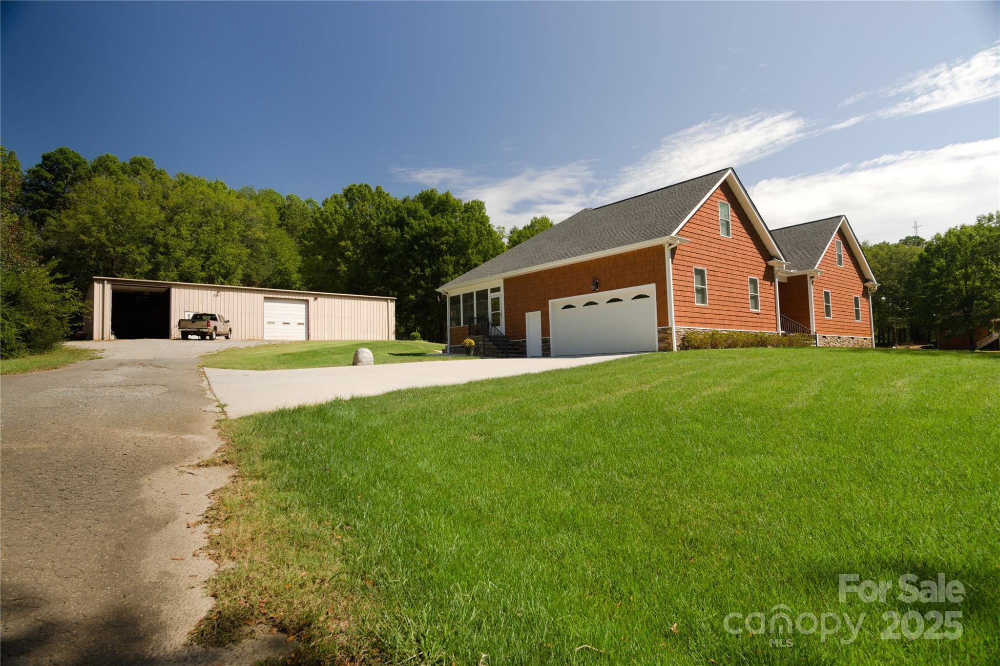 15027 Beatties Ford Road Huntersville, NC 28078 - Photo 6 of 34 a house that is sitting in the grass with tress in the background