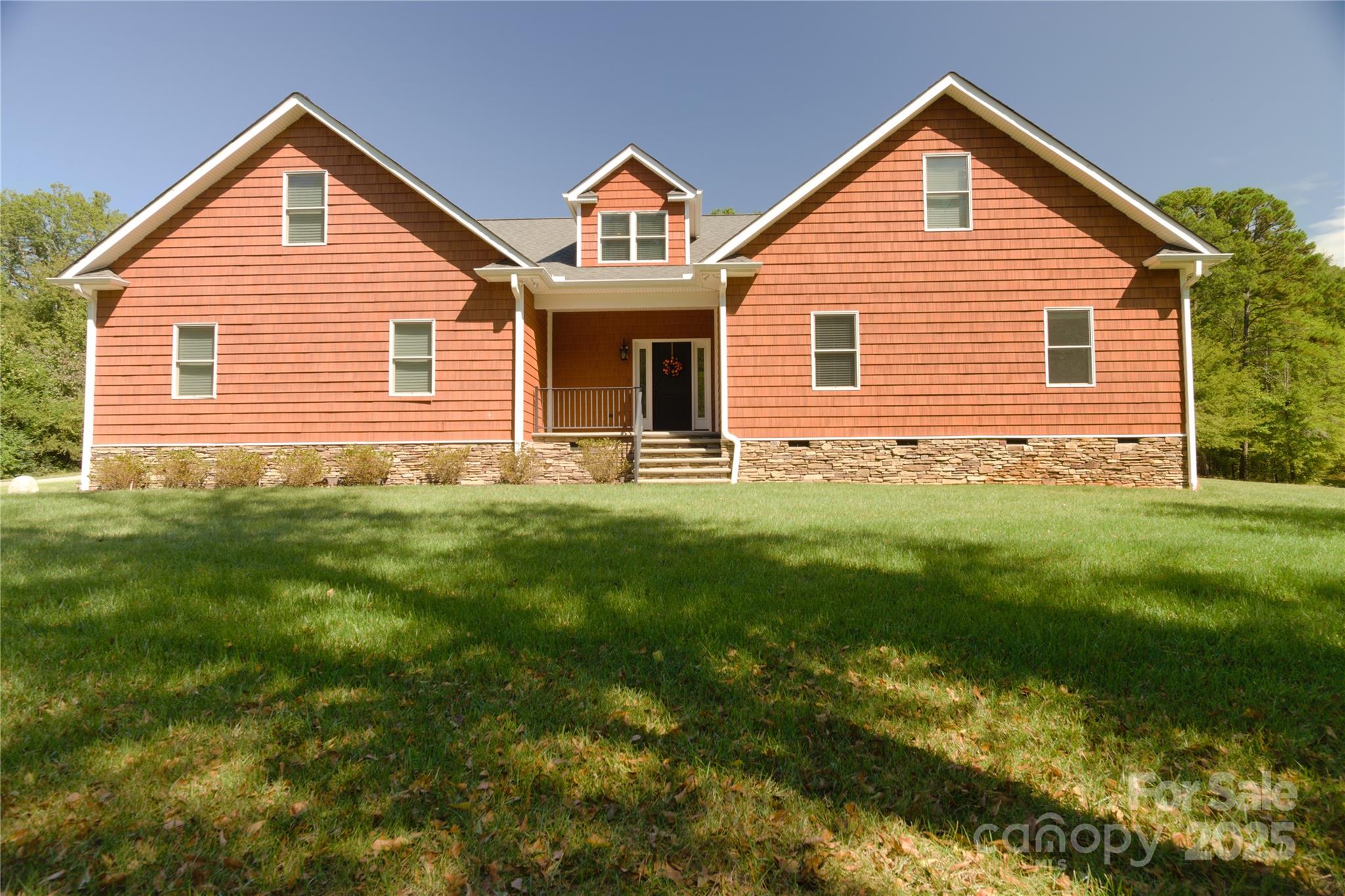 15027 Beatties Ford Road Huntersville, NC 28078 - Photo 7 of 34 a front view of a house with a yard