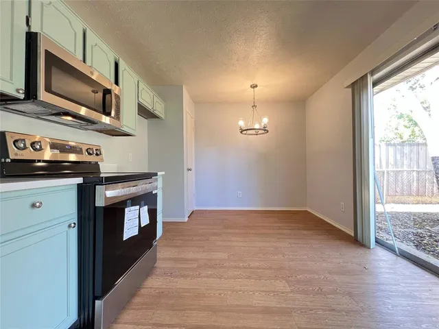 a kitchen with stainless steel appliances granite countertop a stove and a sink