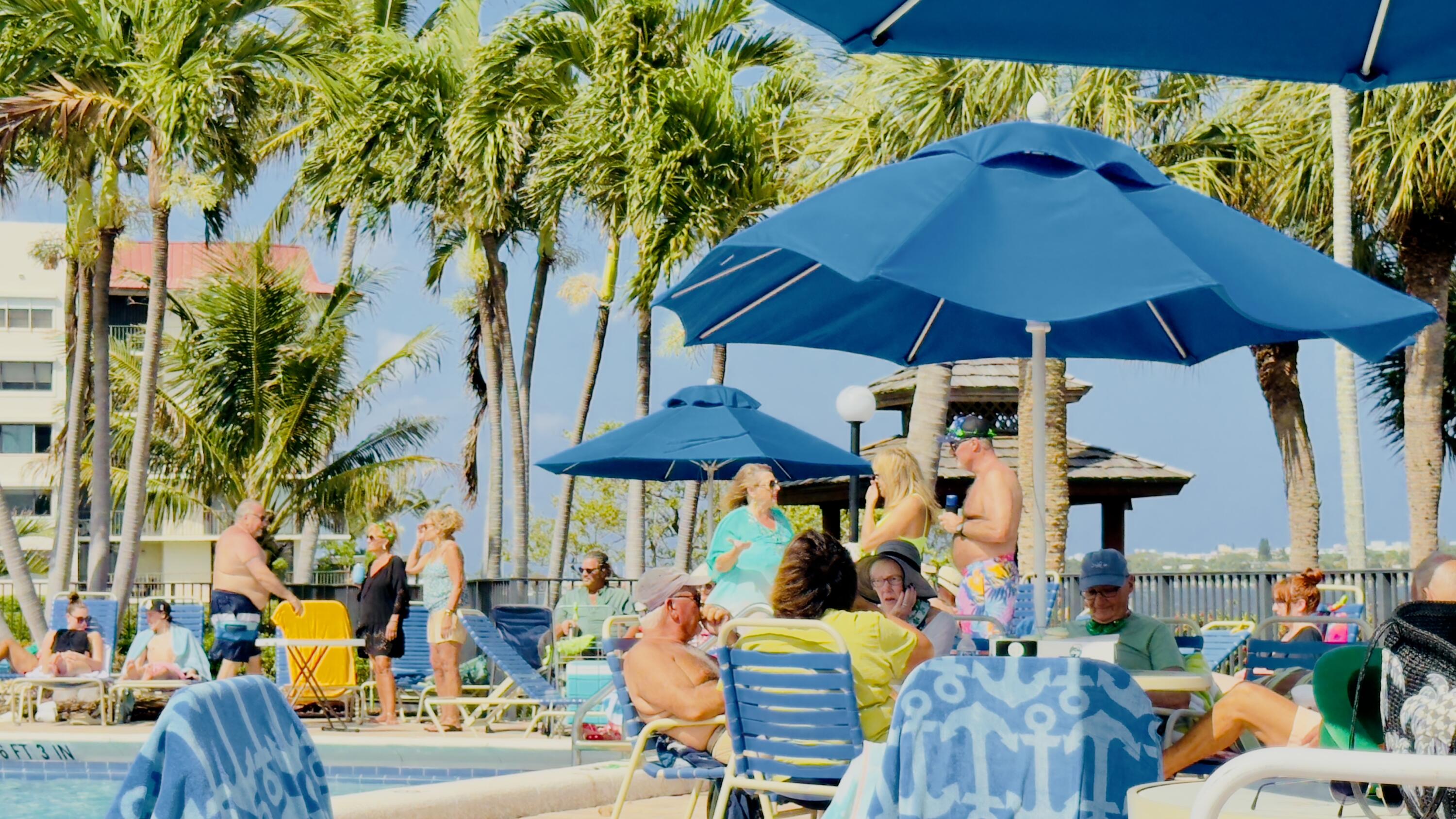 7030 Half Moon Circle, Unit 121 Hypoluxo, FL 33462 - Photo 15 of 74 an outdoor space with furniture and umbrella