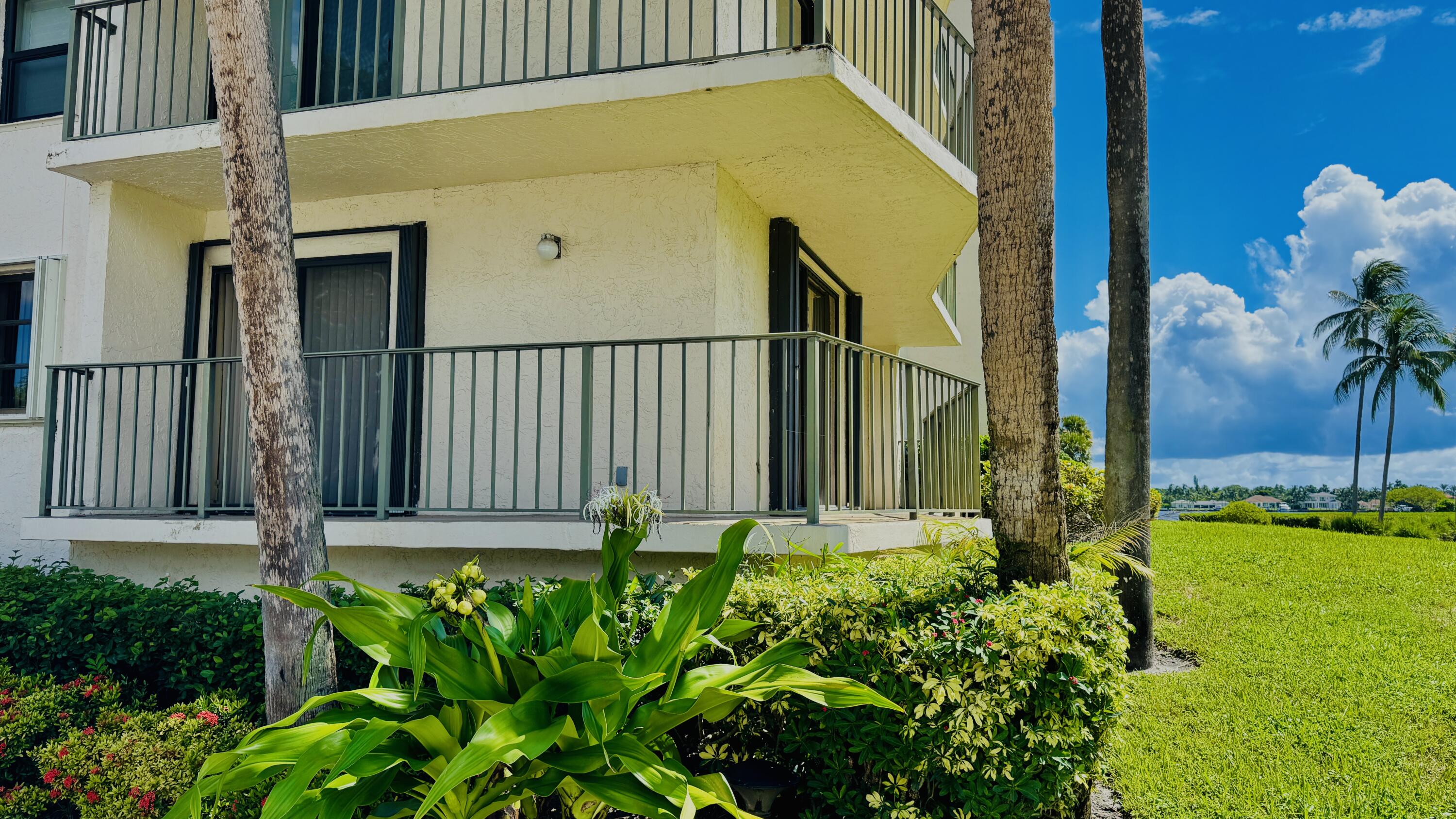 7030 Half Moon Circle, Unit 121 Hypoluxo, FL 33462 - Photo 25 of 74 a front view of a house with garden