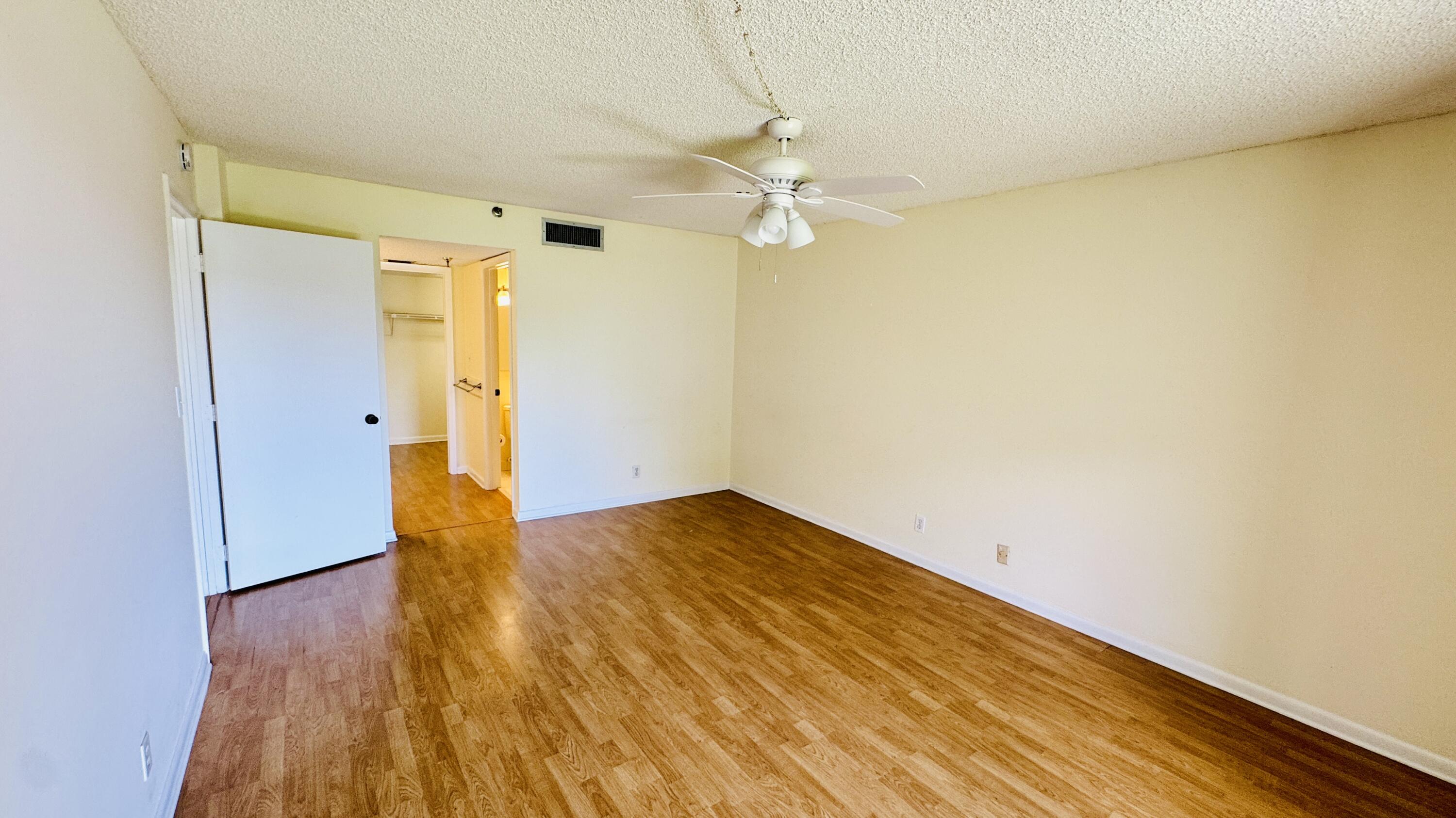 7030 Half Moon Circle, Unit 121 Hypoluxo, FL 33462 - Photo 33 of 74 wooden floor in an empty room with a window