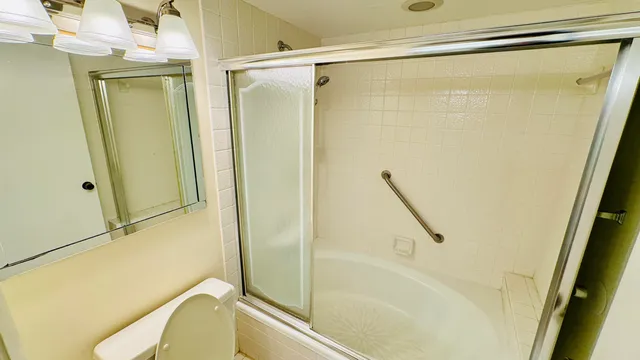 an empty room with wooden floor and a ceiling fan