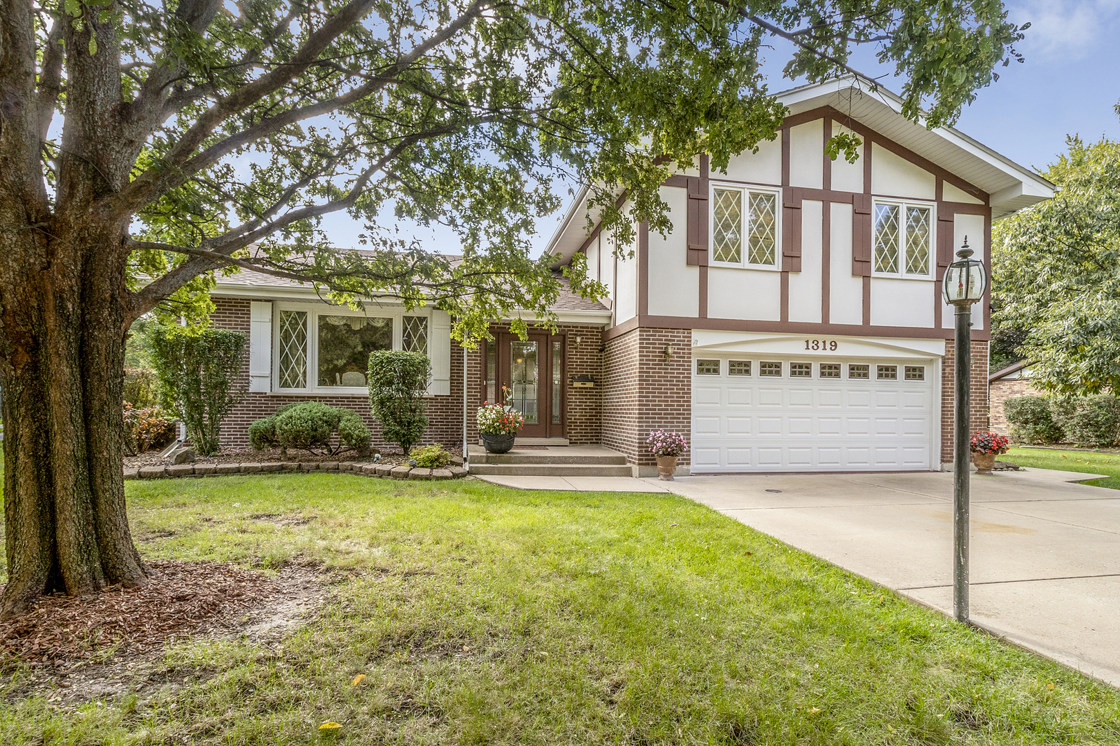 1319 Elder Road Homewood, IL 60430 - Photo 2 of 24 a view of a house with a yard and large tree