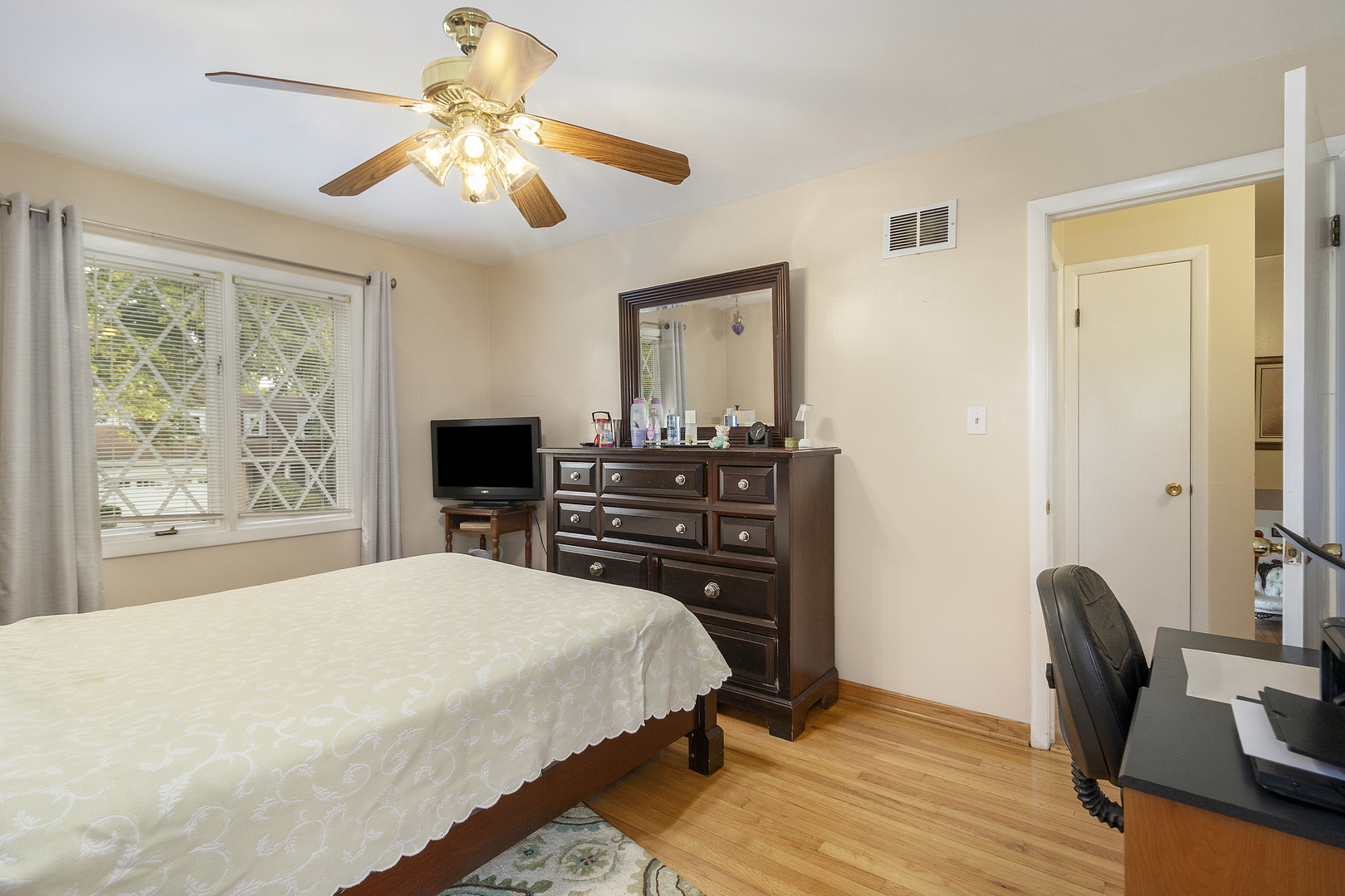 1319 Elder Road Homewood, IL 60430 - Photo 12 of 24 a bedroom with a bed and a chandelier