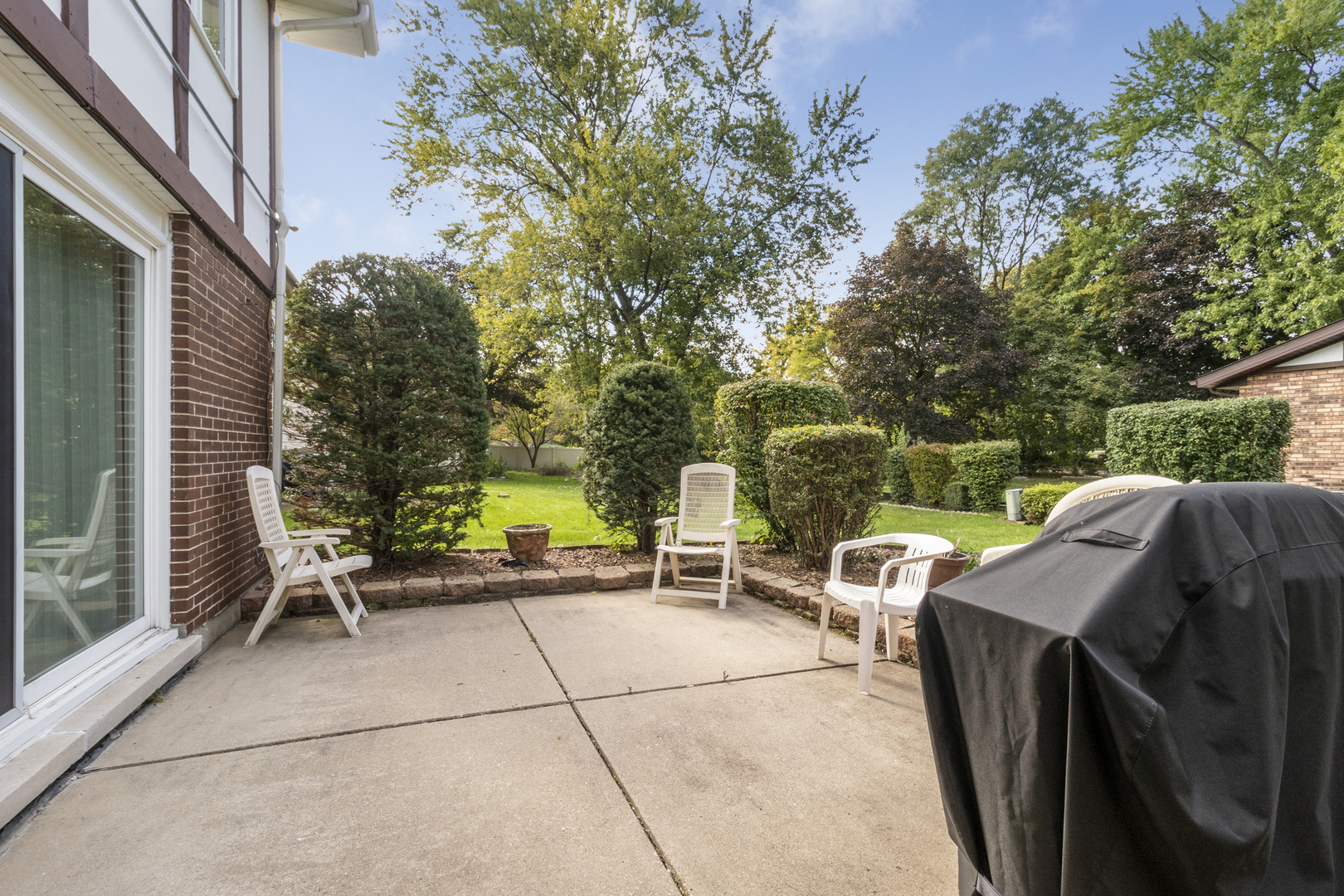 1319 Elder Road Homewood, IL 60430 - Photo 23 of 24 a view of a patio with a table and chairs and a barbeque