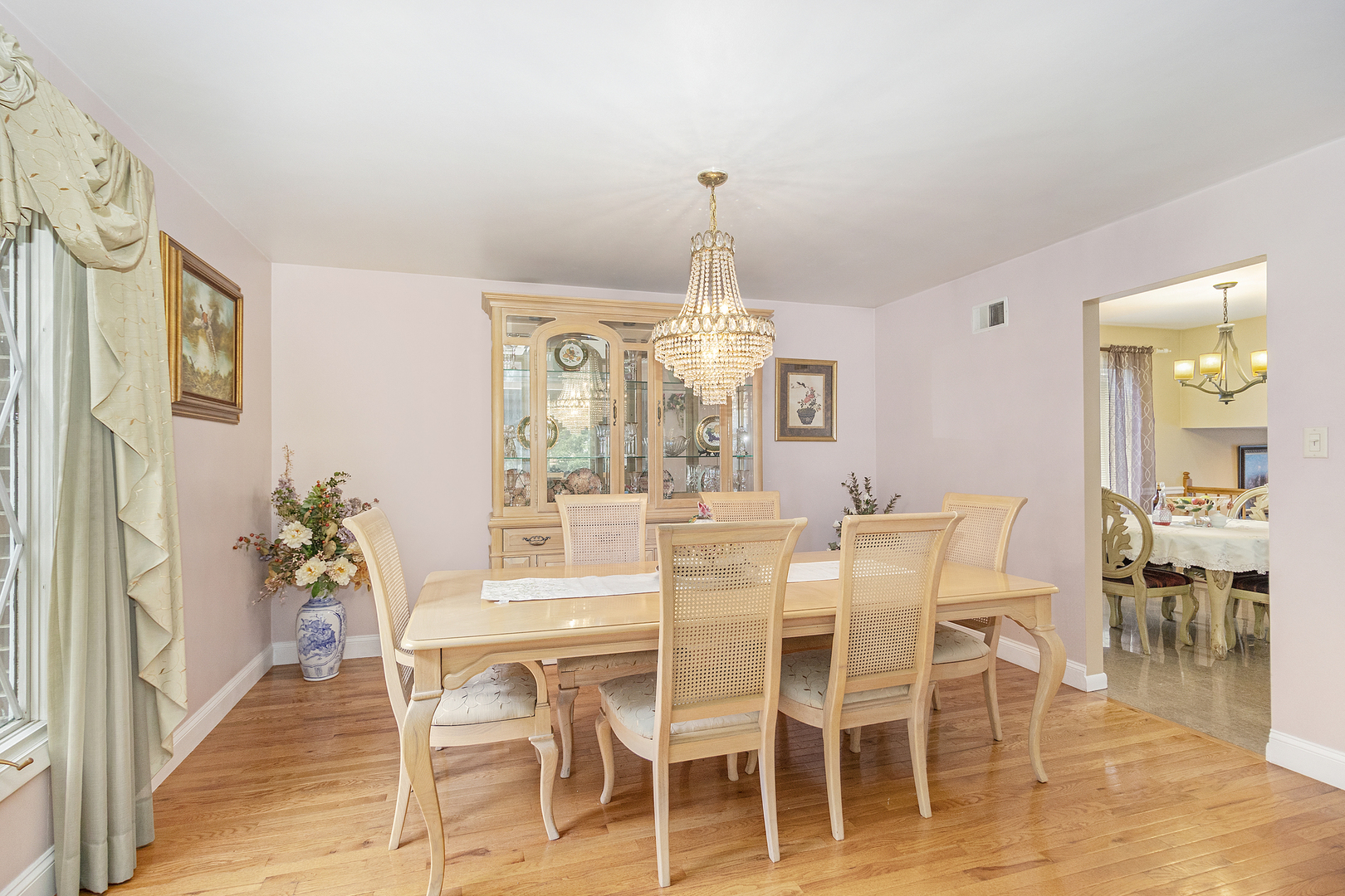 1319 Elder Road Homewood, IL 60430 - Photo 5 of 24 a dining room with furniture a chandelier and wooden floor