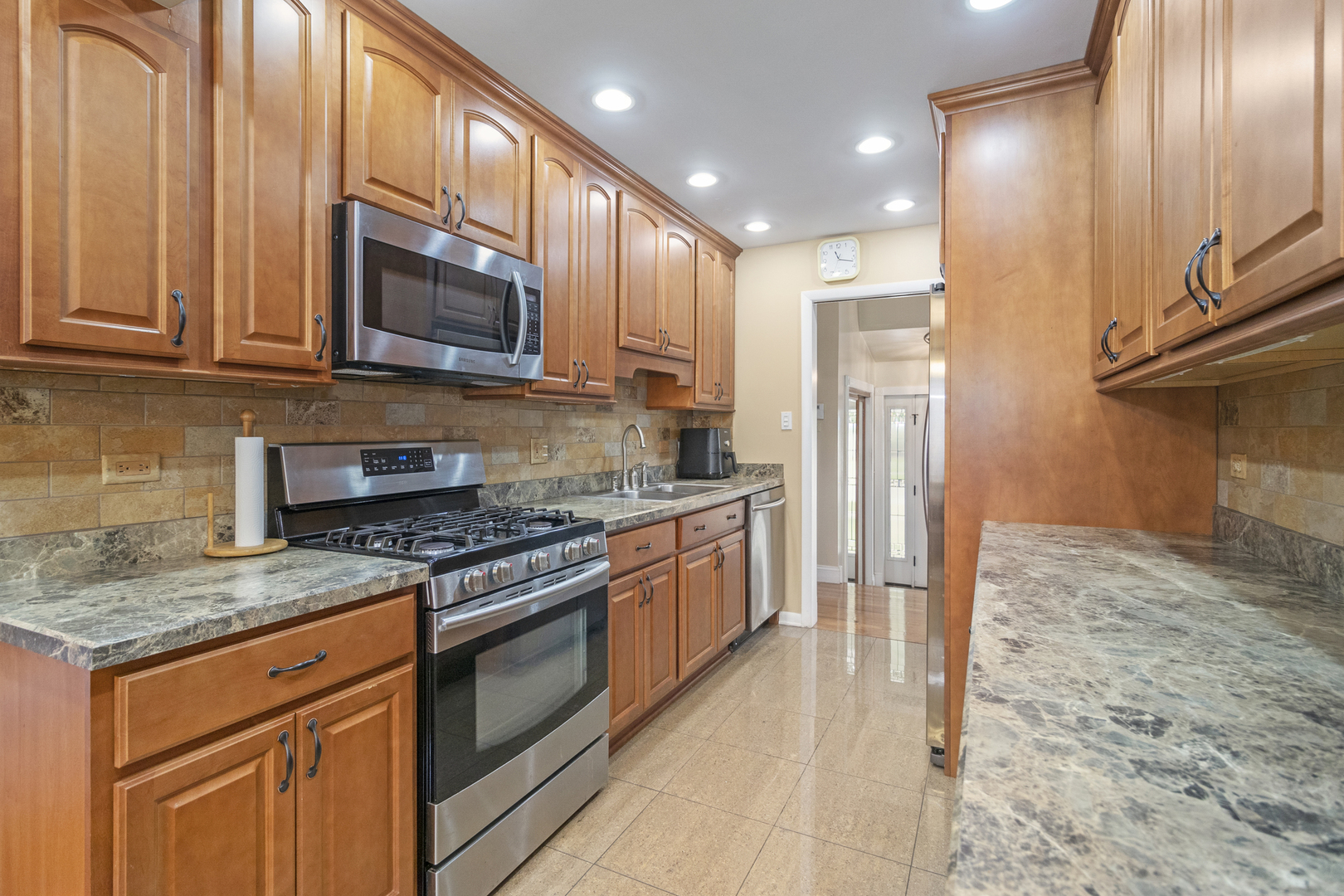 1319 Elder Road Homewood, IL 60430 - Photo 6 of 24 a kitchen with stainless steel appliances granite countertop a stove a sink and a microwave
