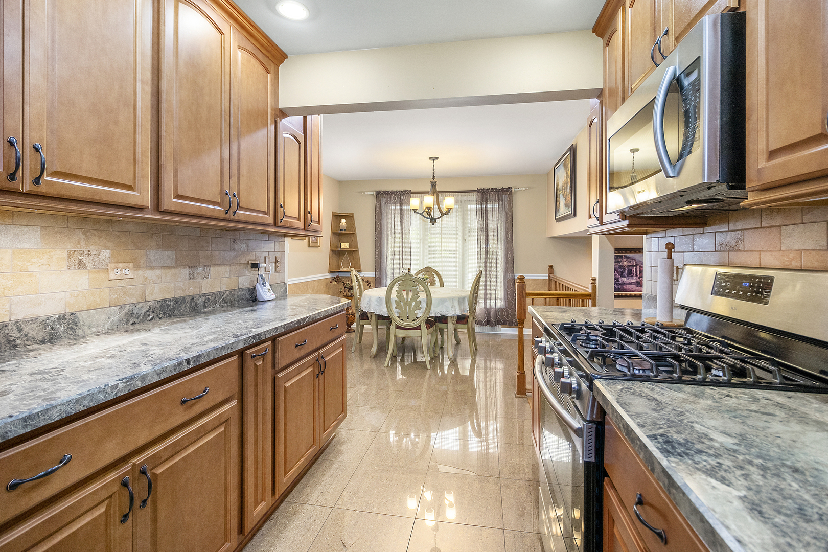 1319 Elder Road Homewood, IL 60430 - Photo 7 of 24 a kitchen with stainless steel appliances granite countertop a stove and cabinets