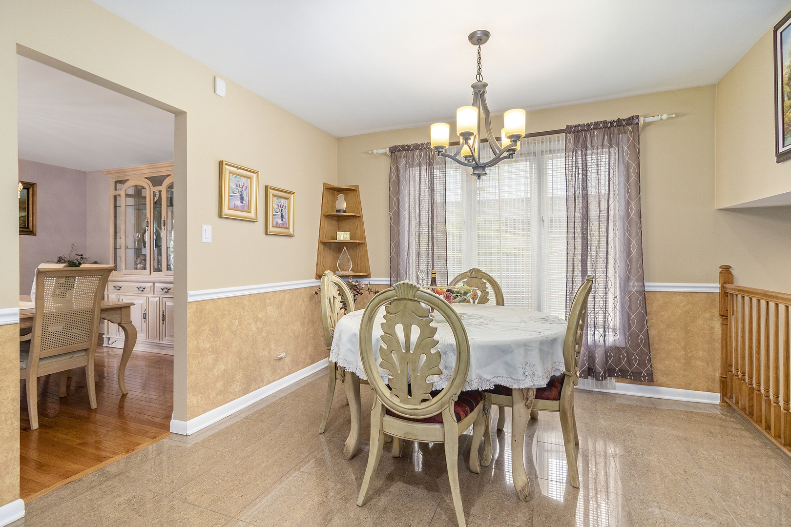 1319 Elder Road Homewood, IL 60430 - Photo 8 of 24 a dining room with furniture a chandelier and wooden floor