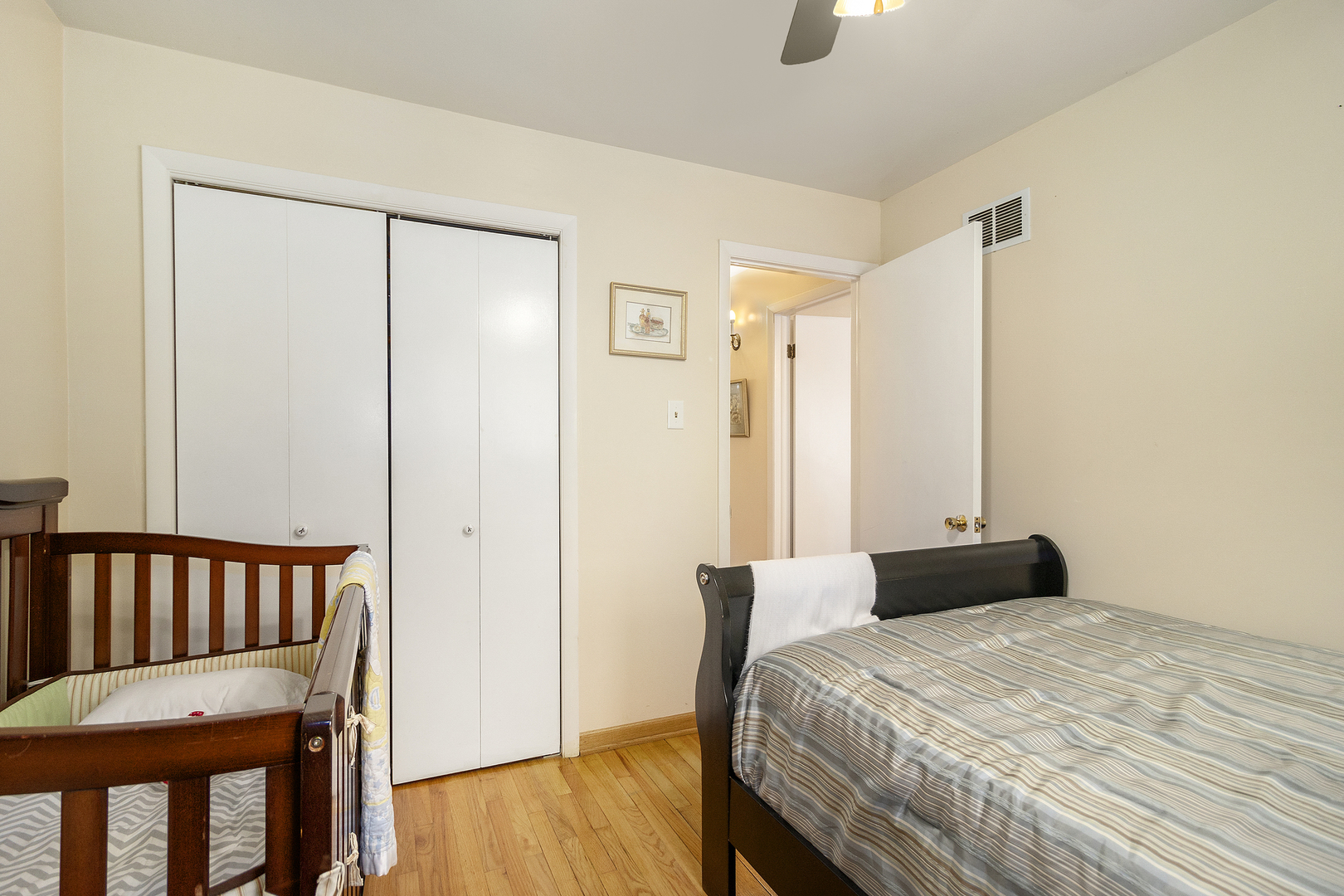 1319 Elder Road Homewood, IL 60430 - Photo 10 of 24 a bedroom with a bed and wooden floor