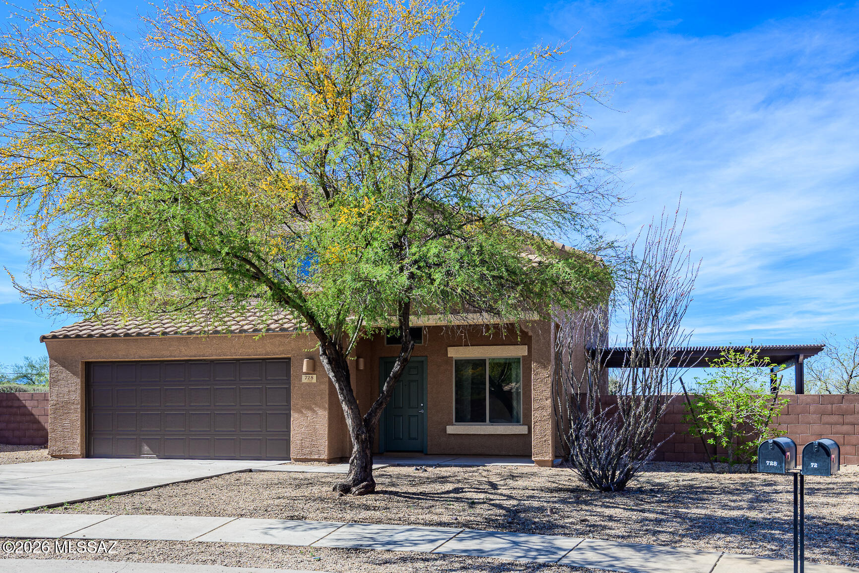 728 South Porter Routh Place Vail, AZ 85641 - Photo 3 of 36 a front view of a house with a yard and garage