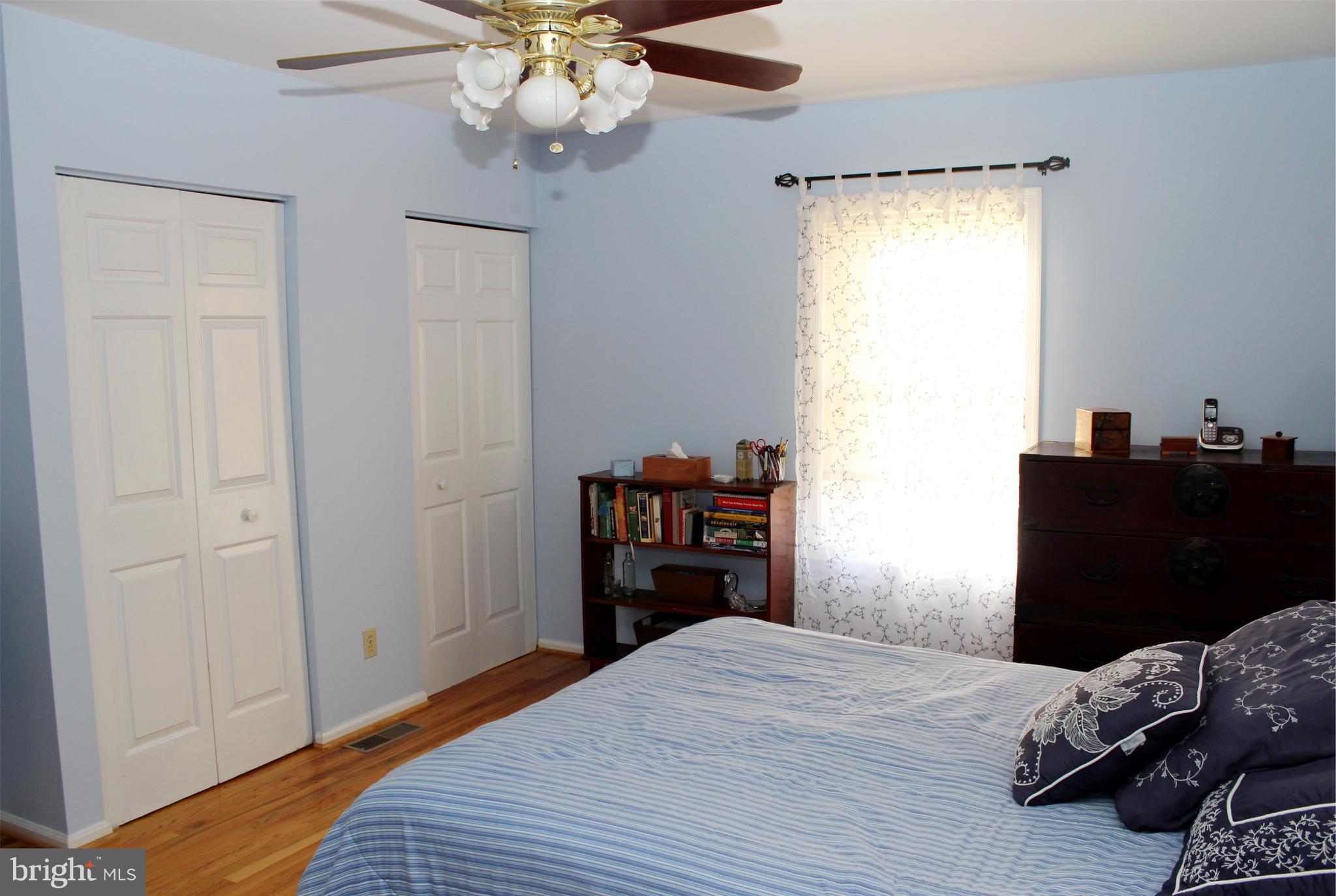 10311 River Road Rixeyville, VA 22737 - Photo 20 of 30 a bedroom with a bed and wooden floor