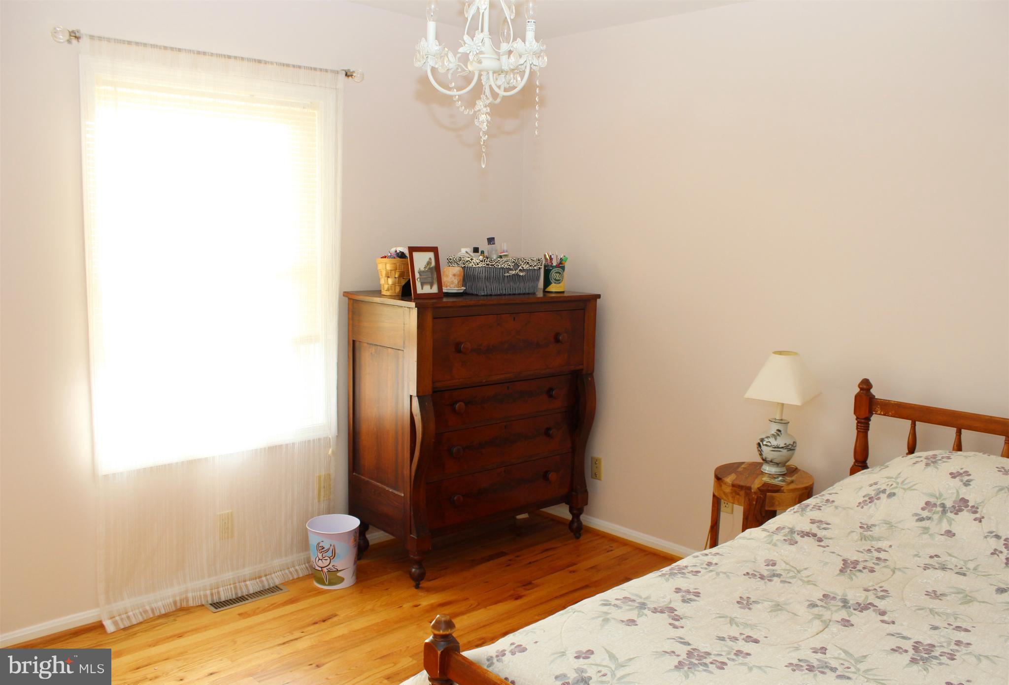 10311 River Road Rixeyville, VA 22737 - Photo 22 of 30 a bedroom with a bed and a dresser
