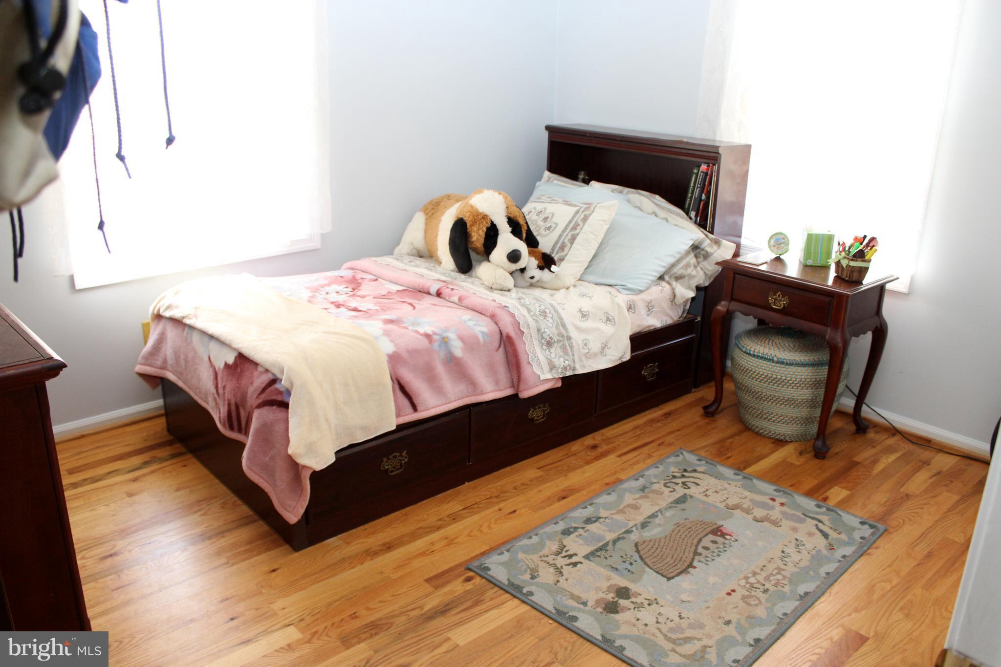 10311 River Road Rixeyville, VA 22737 - Photo 23 of 30 a bed sitting in a bedroom next to a window