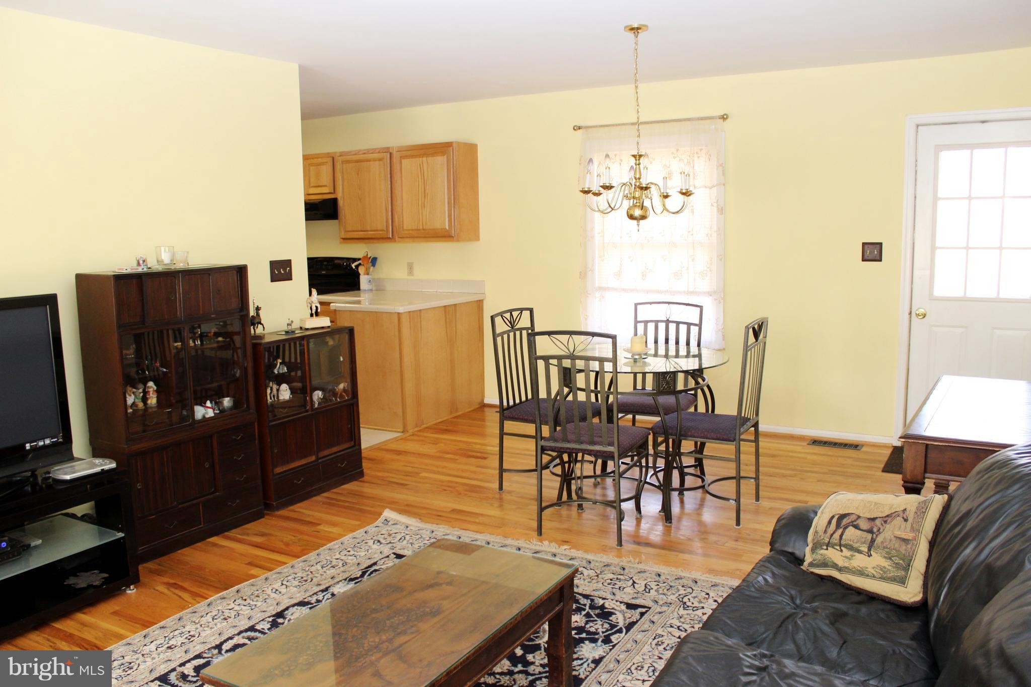10311 River Road Rixeyville, VA 22737 - Photo 9 of 30 a living room with furniture and a chandelier