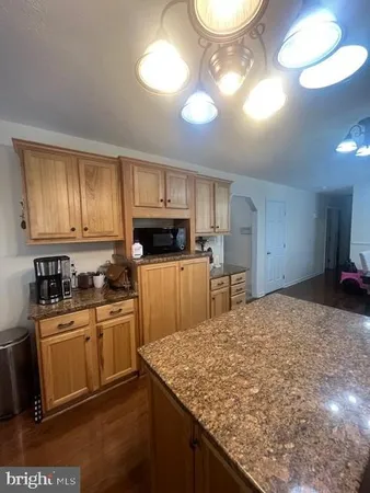 a kitchen with cabinets a sink and appliances