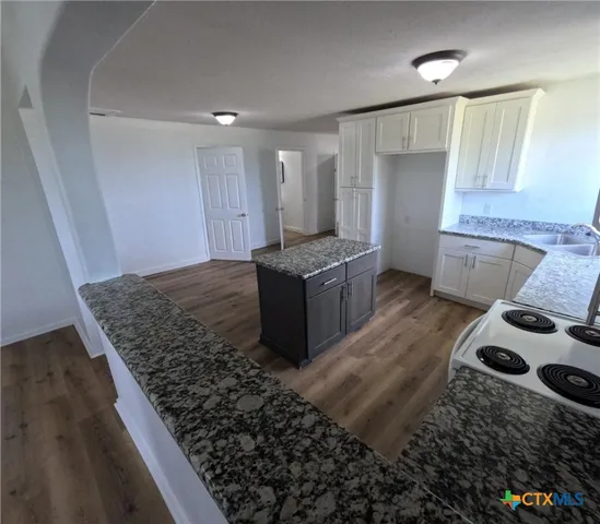 a kitchen with a stove and a refrigerator