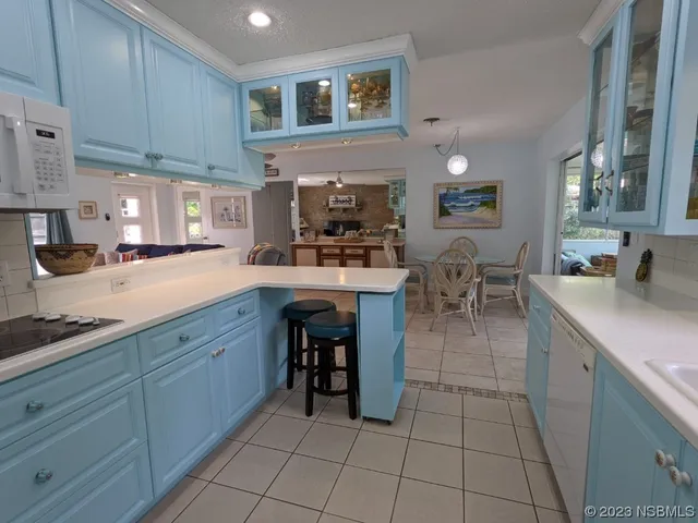 a living room with furniture two window and a table