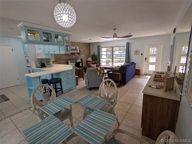 a living room with furniture and a view of kitchen
