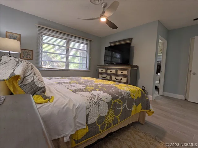 a view of a backyard with table and chairs potted plants with wooden roof and potted plants