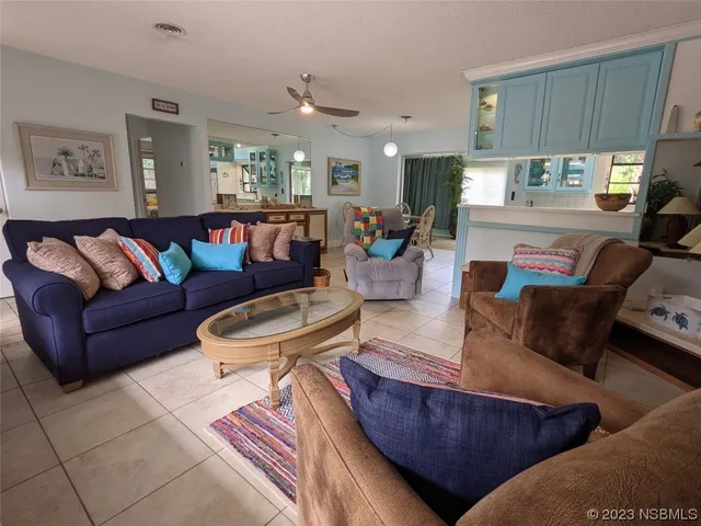 a view of a dining room with furniture a chandelier and wooden floor