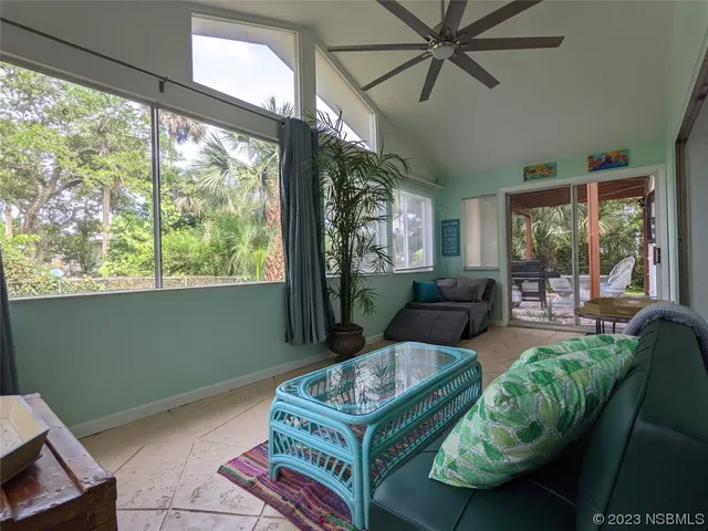 a view of a a dining room with furniture window and wooden floor