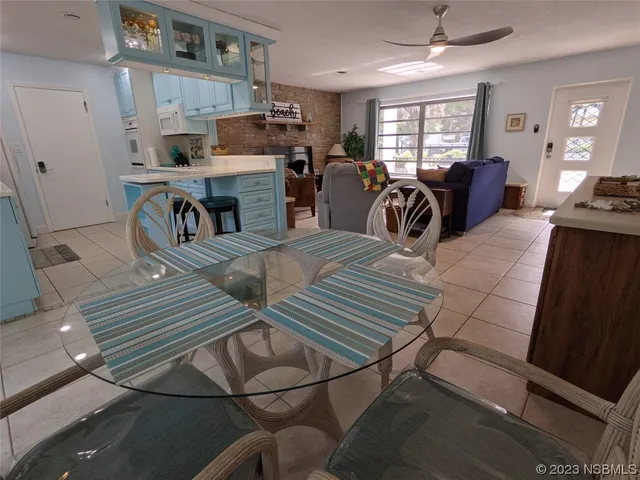 a kitchen with a table chairs and a window
